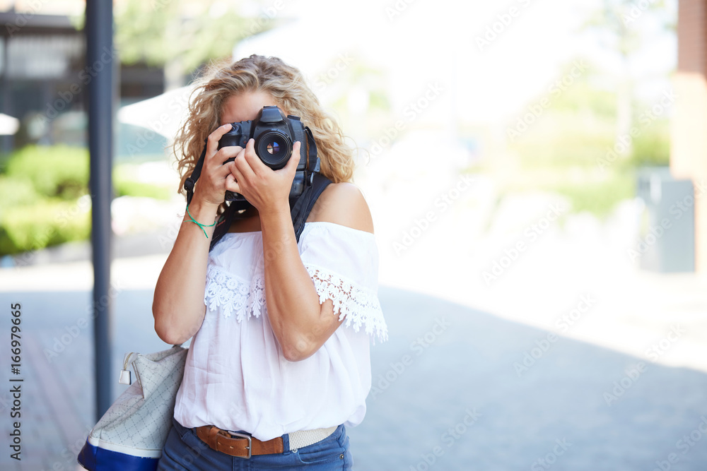 Tourist with photo camera shooting on the street Tourist with photo camera shooting on the street