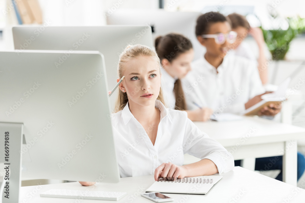 portrait of pensive teenage girl in white shirt studying in classroom portrait of pensive teenage girl in white shirt studying in classroom