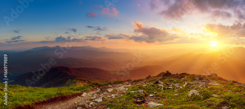 Fototapeta Naklejka Na Ścianę i Meble -  Amazing mountain landscape with colorful vivid sunset on the cloudy sky, natural outdoor travel background. Beauty world. Panoramic view.