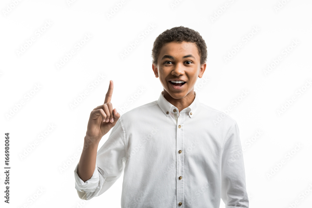 portrait of excited african american teenager pointing with finger up isolated on white portrait of excited african american teenager pointing with finger up isolated on white
