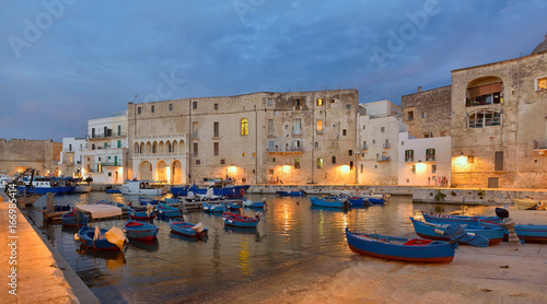 Obraz na plátně Fishing boats in Monipoli city bay with cloudy sky background, southern Italy