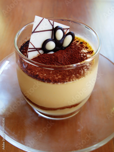 Tiramisu in a glass cup on table