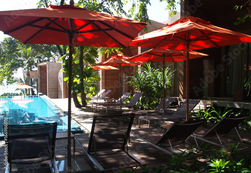 Rayong - 22 November 2011 - Relaxing rattan chairs besides swimming pool ,Thailand