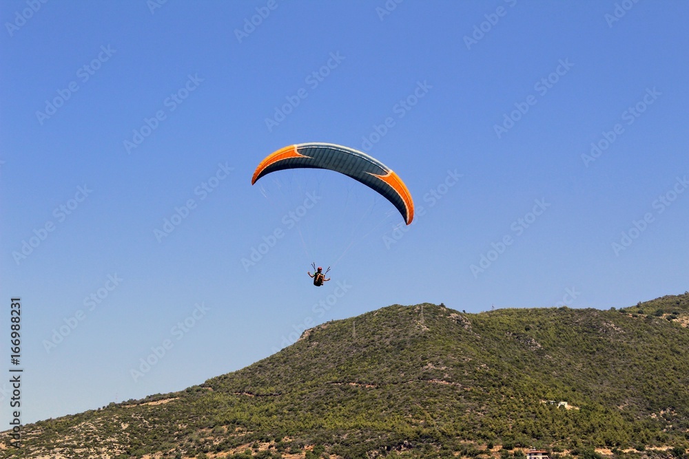 Paraglider landing in a special zone at Cleopatra Beach in Alanya (Turkey).