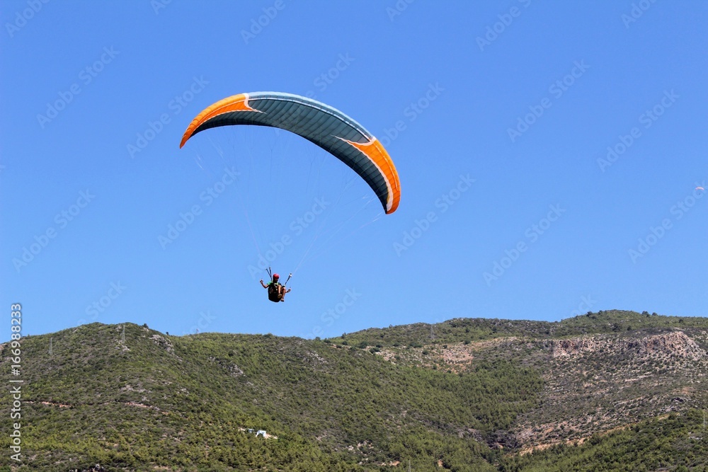 Paraglider landing in a special zone at Cleopatra Beach in Alanya (Turkey).