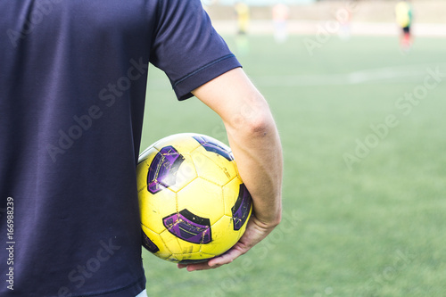 man holding a soccer ball on the field