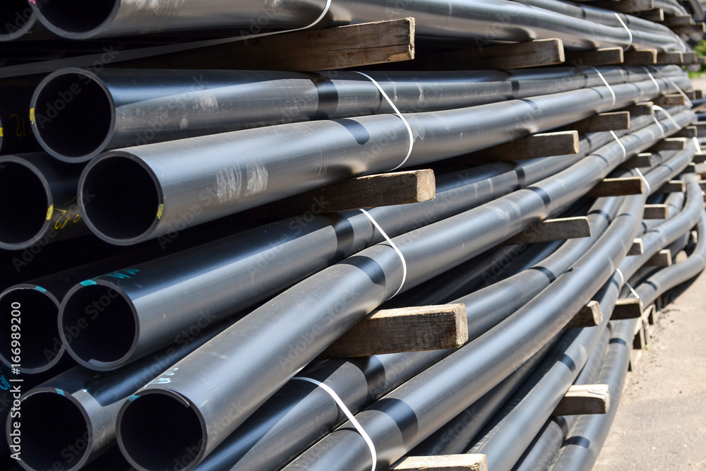 Plastic pipes in stock of finished products stacked in packs Plastic pipes in stock of finished products stacked in packs