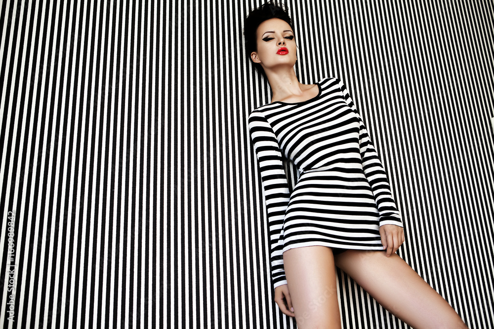 fashion woman in striped dress on  background. - obrazy, fototapety, plakaty 