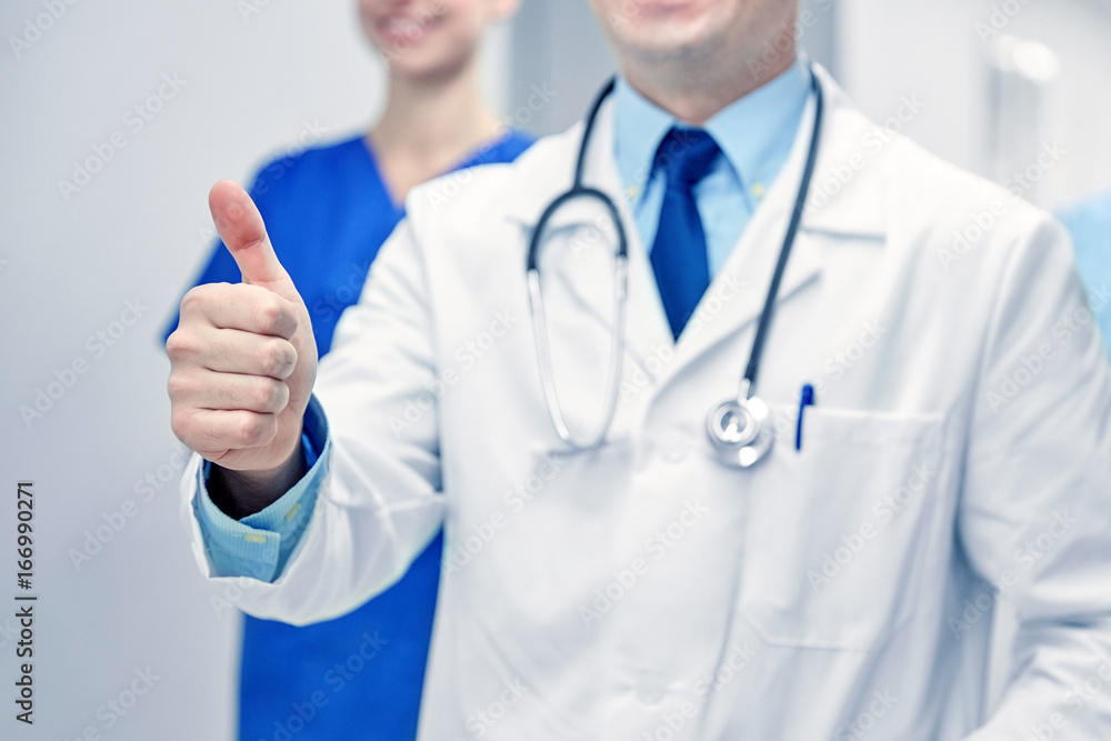 close up of doctors at hospital showing thumbs close up of doctors at hospital showing thumbs