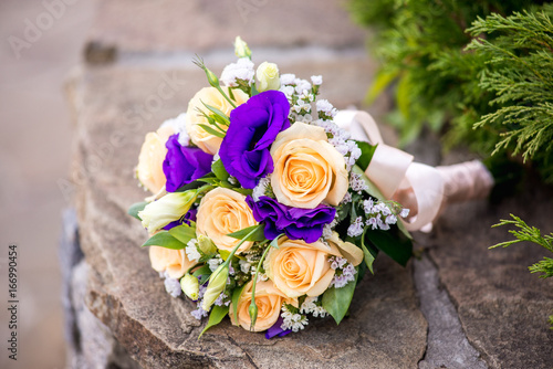 Wedding bouquet of roses on a bench