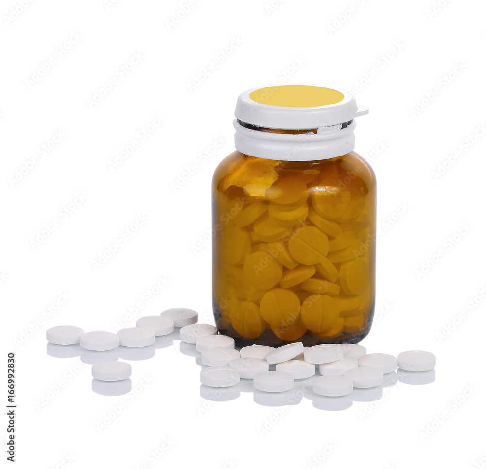 Pill bottle spilling pills on to surface isolated on a white background. Pill bottle spilling pills on to surface isolated on a white background.