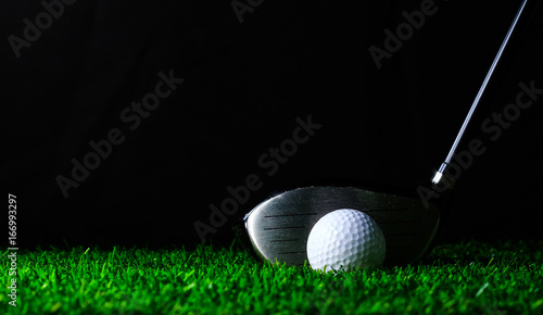 Golf club and golf-ball on green grass