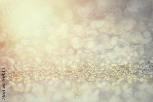 defocus of glitter vintage lights background. gold, silver, blue and black for Christmas and new year background.