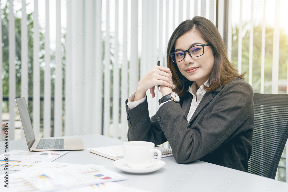 Modern asian business woman working in office with copy space and sun rise. Modern asian business woman working in office with copy space and sun rise.