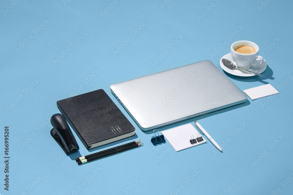 The laptop, pens, phone, note with blank screen on table The laptop, pens, phone, note with blank screen on table