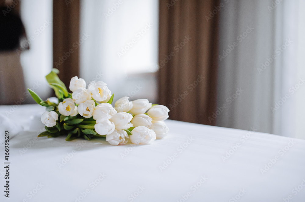 Bouquet of tulips on white bed Bouquet of tulips on white bed