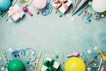 Birthday party banner or background with colorful balloon, gift, carnival cap, confetti, candy and streamer. Flat lay style. Copy space for greeting text.