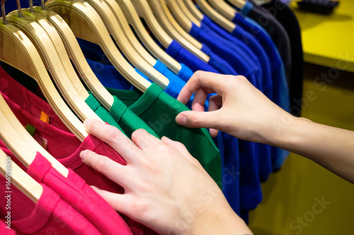 Woman Choosing Trendy Colorful T-shirt