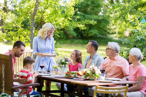 happy family having dinner or summer garden party