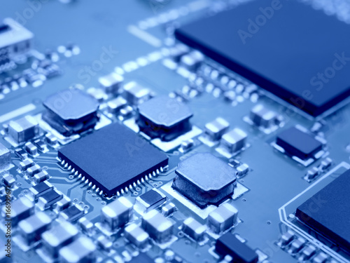 Closeup image of microprocessor on electronic circuit board. Blurred and toned image. Shallow DOF.