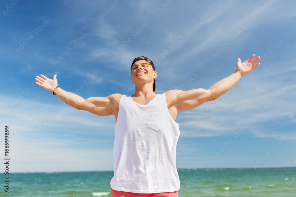 smiling young man on summer beach