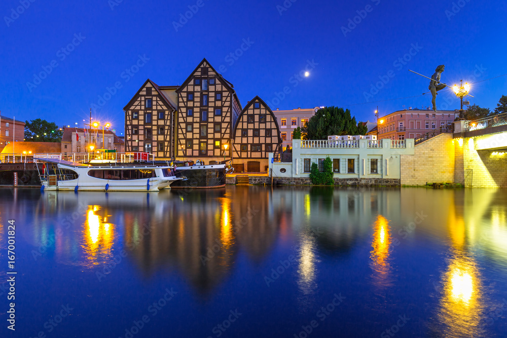 Architecture of Bydgoszcz city with reflection in Brda river at night, Poland