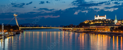 Night view on new bridge in Bratislava with castle on right side and lights reflection on river Dunaj.