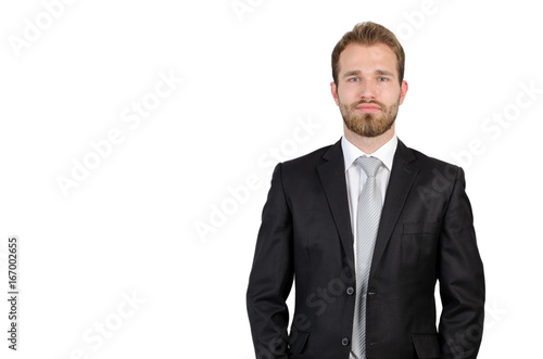 Portrait of young businessman standing in studio