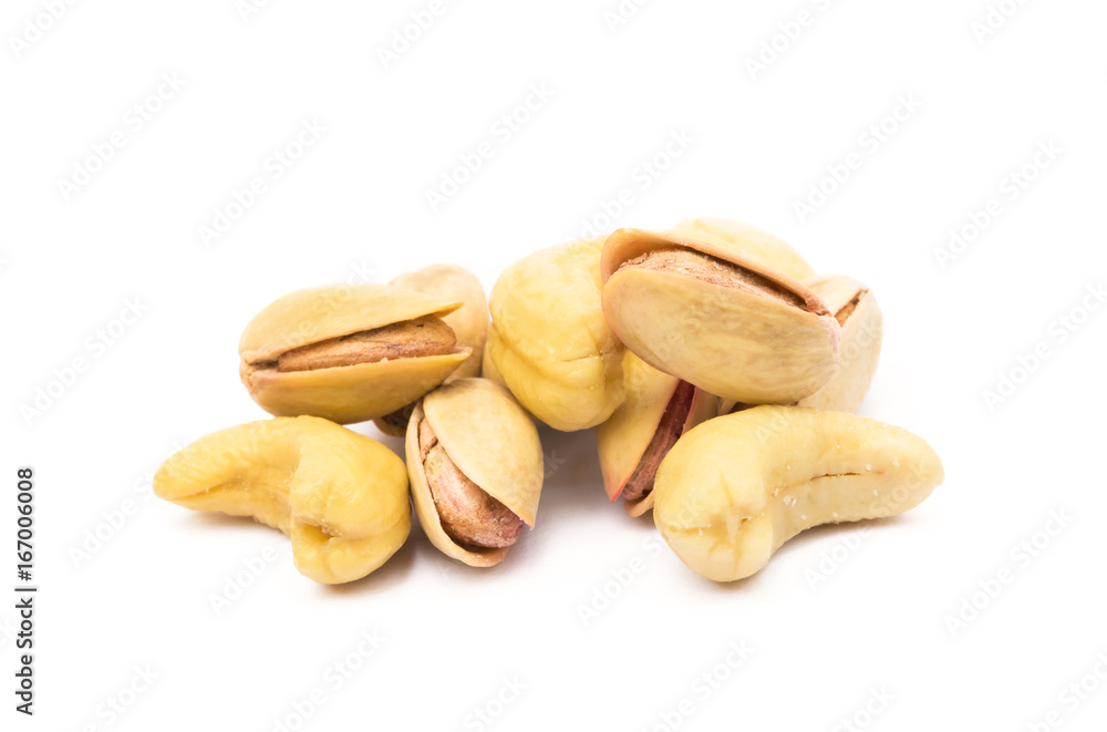 Pile of roasted pistachios and cashew isolated on white background Pile of roasted pistachios and cashew isolated on white background