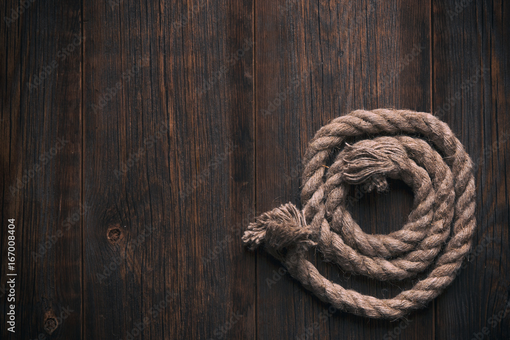 Twisted rope on a wooden floor Twisted rope on a wooden floor