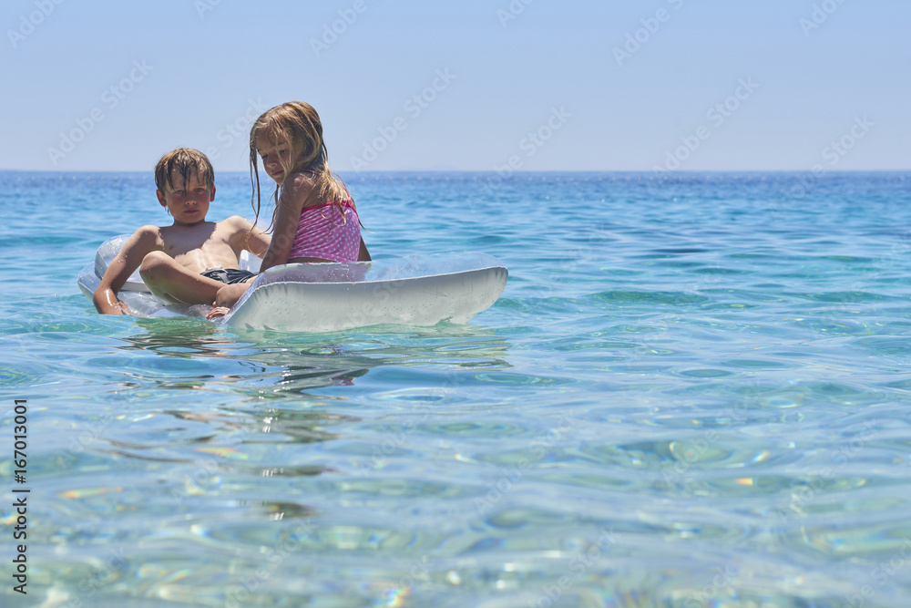 Φωτογραφία Happy Sister and Brother Children Playing with Inflatable Mattress at Adriatic Blue Sea, Hvar island, Croatia