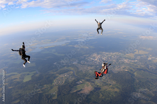 Three skydivers in the sky