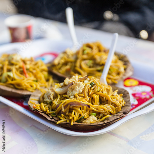 Tibetan fried noodle Thukpa served in dry leaves plate in village market in winter at Gangtok, Sikkim. India.