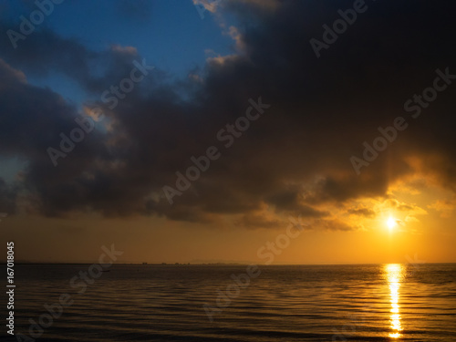 beautiful sunset over water and silhouette fishing boat