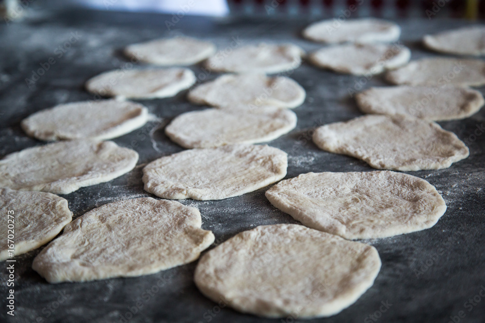 Raw dough for pita on the table Raw dough for pita on the table
