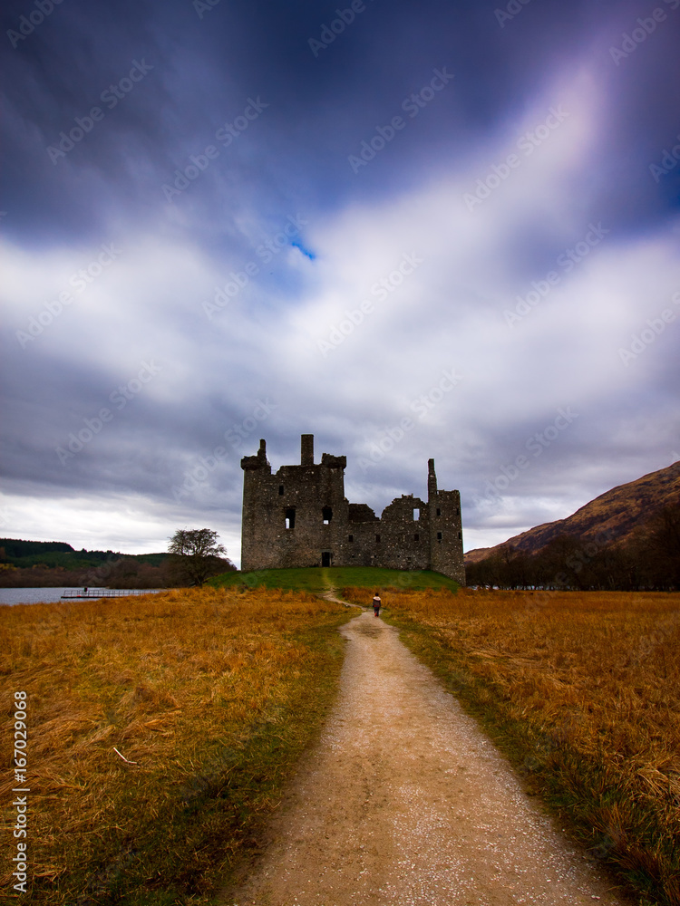 Lonely kid walking towards an old castle Lonely kid walking towards an old castle