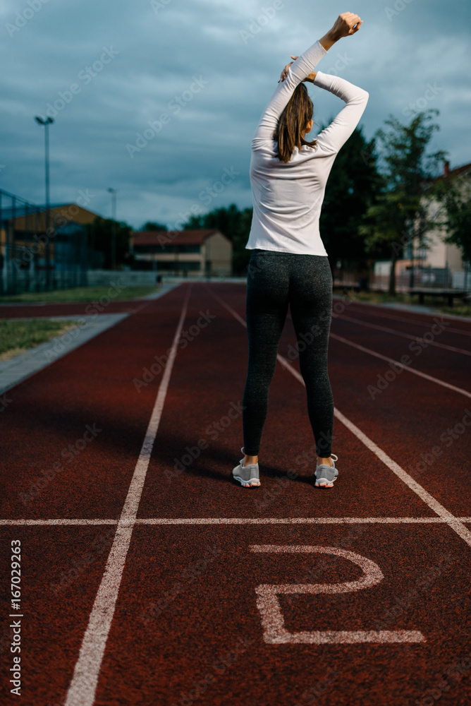 Fototapeta premium Stretching in dawn before a run