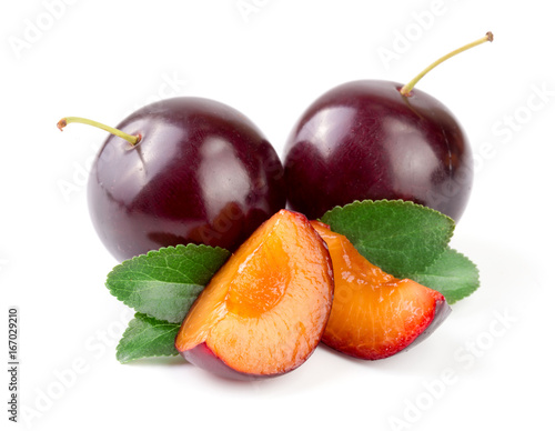 Purple plum with leaves isolated on white background