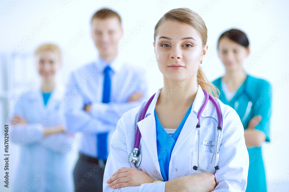 Attractive female doctor with medical stethoscope in front of medical group Attractive female doctor with medical stethoscope in front of medical group