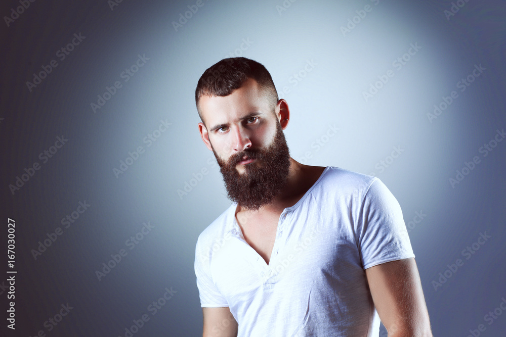 Portrait of handsome man standing, isolated on grey background Portrait of handsome man standing, isolated on grey background