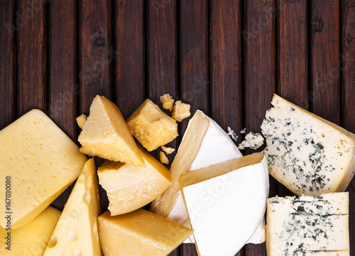 Photography Various types of cheese on rustic wooden table, top view