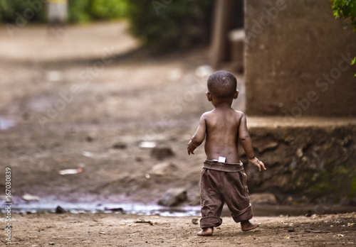 Orphan boy in an impoverished African village. photo