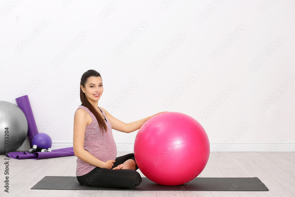 Young pregnant woman training in gym. Health concept Young pregnant woman training in gym. Health concept