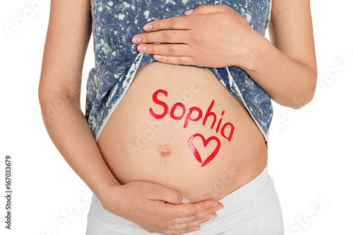 Young pregnant woman with name SOPHIA written on her tummy, closeup. Concept of choosing baby name