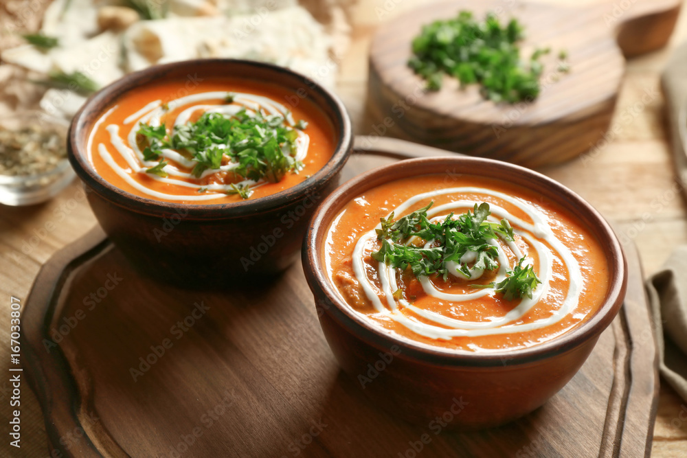 Bowls with delicious Murgh Makhani on table Bowls with delicious Murgh Makhani on table