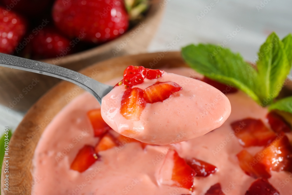 Spoon with delicious strawberry yogurt, closeup Spoon with delicious strawberry yogurt, closeup