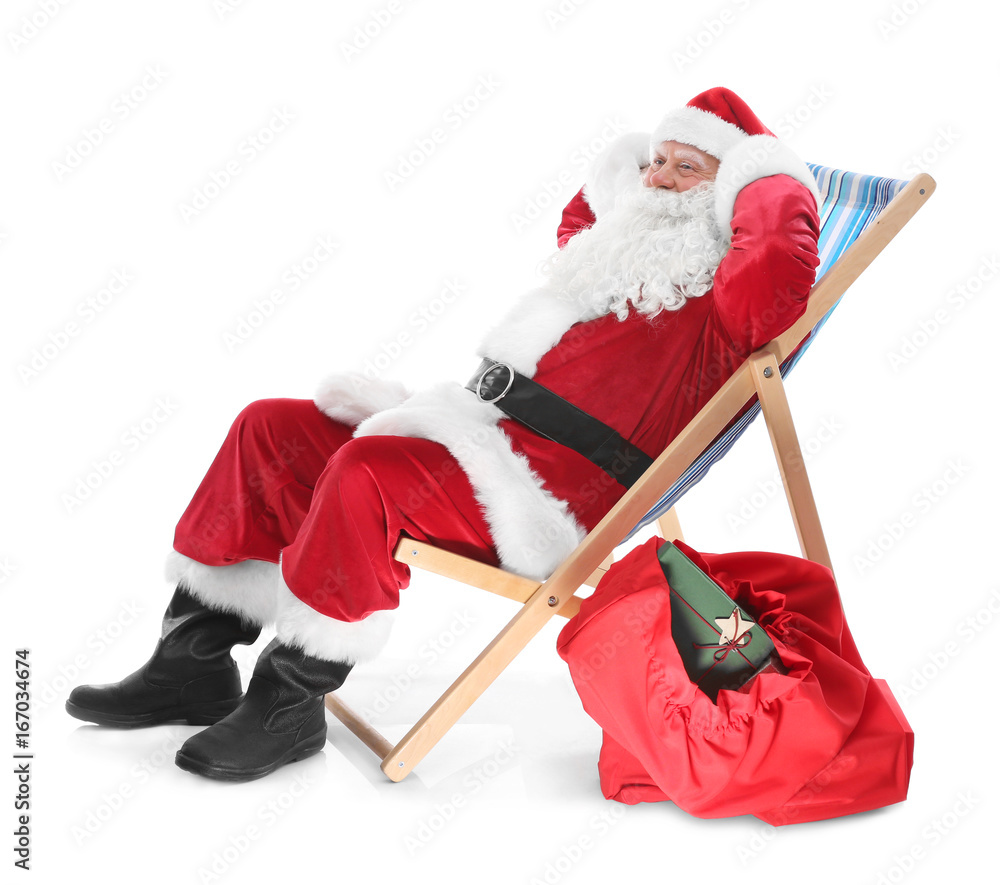 Authentic Santa Claus sitting on a beach chair against white background ...