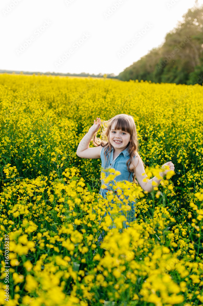 A young girl walks the yellow field A young girl walks the yellow field