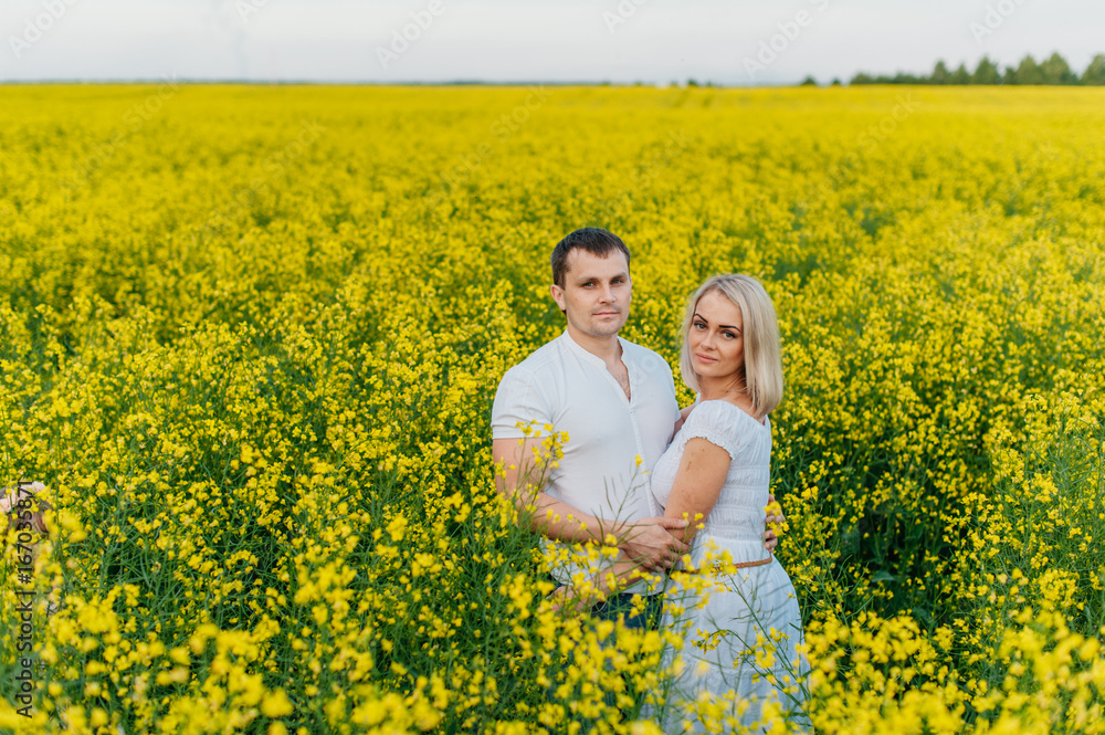 Young couple in a yellow field Young couple in a yellow field