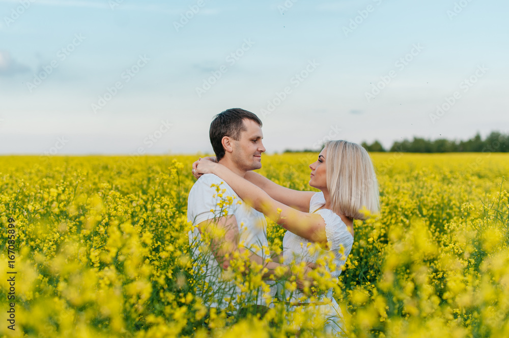 Young couple in a yellow field Young couple in a yellow field